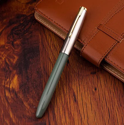 Green pen with silver clip on a brown leather surface