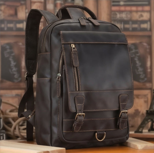 Brown leather backpack on a wooden surface with a blurred background